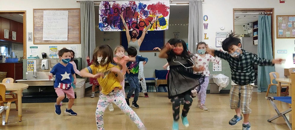 kids with face masks dancing